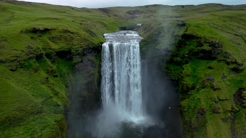Spectacular Skogafoss Waterfall Cascading Down Green Cliffs in Iceland