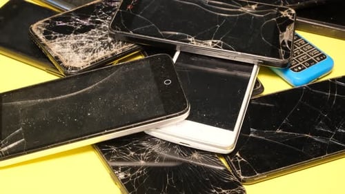 Closeup of Used Smartphones with a Broken Screen