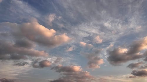 Golden Hour Clouds Floating in a Blue Sky