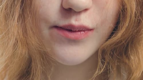 Young Adult Chewing and Smiling, Close Up