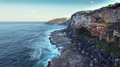 Majestic Cliff Overlooking Ocean With Distinct Rock Layers And Vibrant Coastal Environment