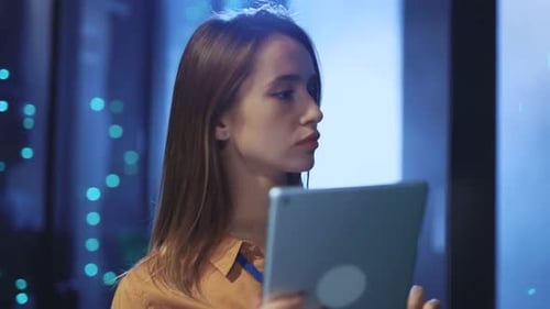 Woman holding tablet in a data center