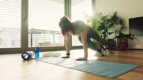 Woman Doing Mountain Climber Exercise on Yoga Mat
