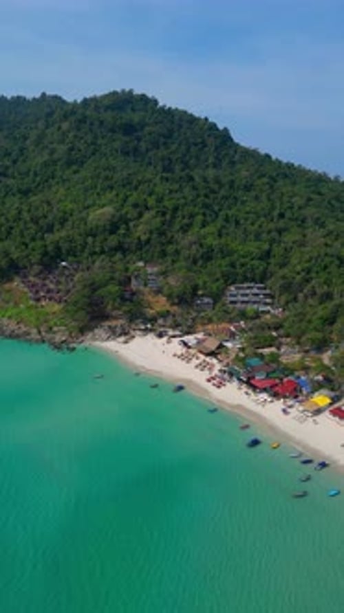 Drone Spirals Toward Langkawi's Turquoise Jungle Beach