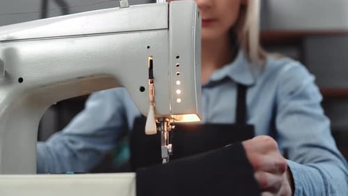 Fashion Designer Sewing on a Machine Close Up