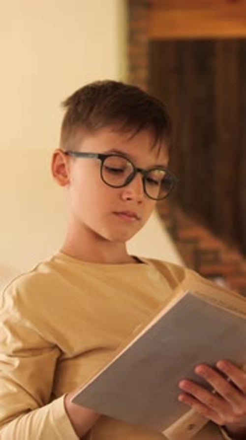 Young Student Reading a Book in a Library Surrounded By Knowledge