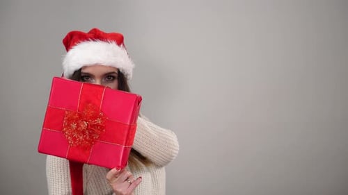 Young Woman Holding Christmas Gift Box Smiling