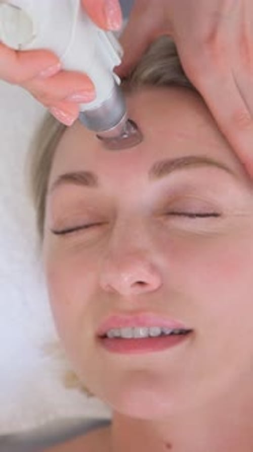 Closeup of a Woman Having a Hydrodermabrasion Facial Peeling Treatment at a Cosmetic Beauty Spa