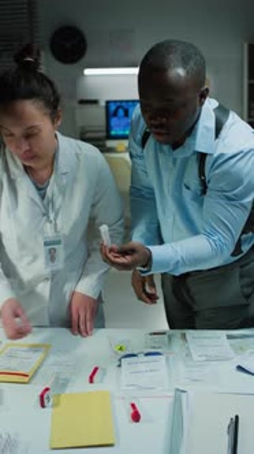 Two People Analyzing Evidence in Workplace