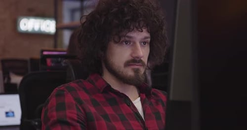 Businessman or Software Engineer Sitting in a Modern Coworking Office and Working at a Computer