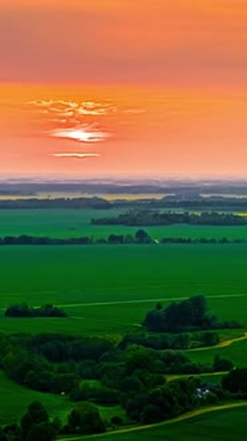 Vivid Sunset Over Flat Agricultural Fields
