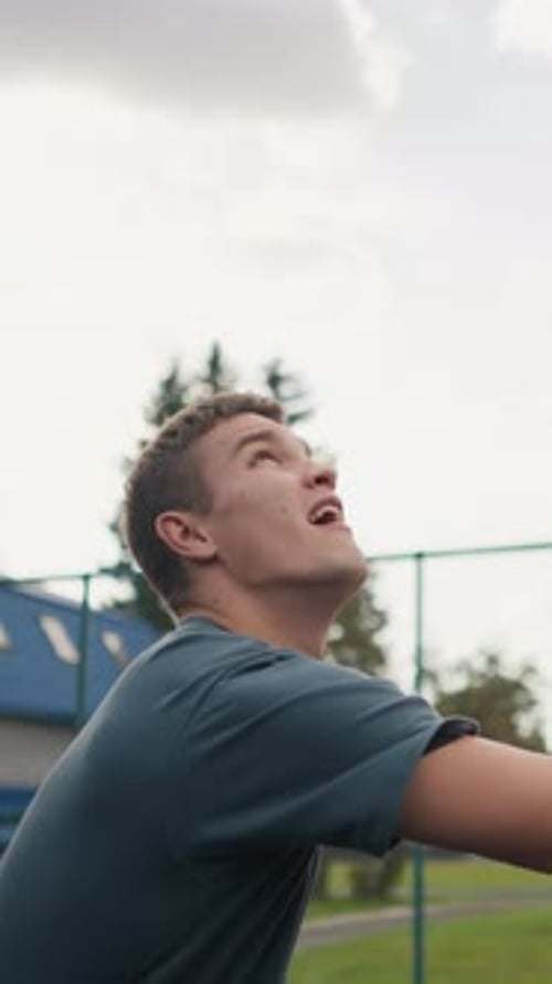 Man Playing Volleyball Outdoors on Overcast Day