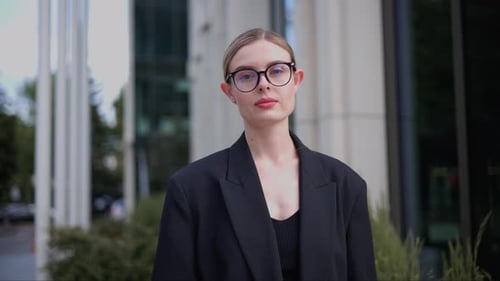 European Businesswoman Girl Adjusts Her Glasses Turns Head Looks to the Camera