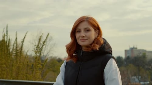 Young mother enjoys a sunny day at the park with her baby in a stroller