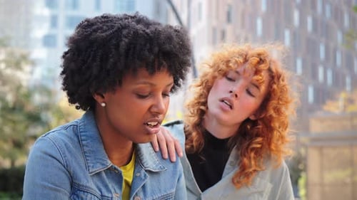 Woman Comforts Friend in Urban Environment