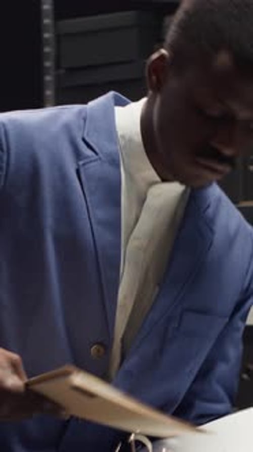 Man Reviewing and Signing Documents in an Office