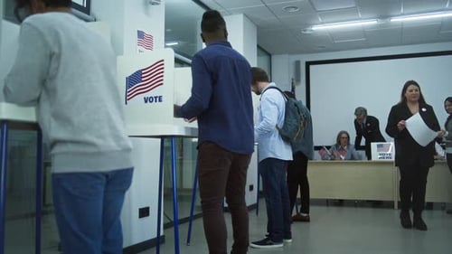 Multi Ethnic American Citizens Vote in Booths in Polling Station