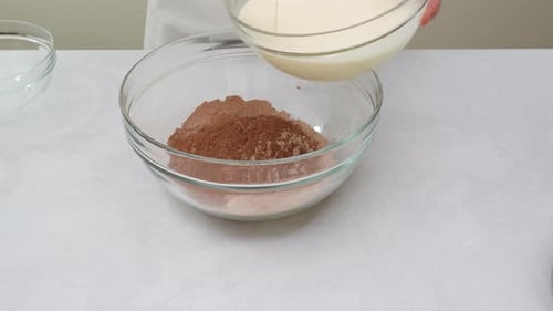 Woman Adding Cream to Chocolate Mixture