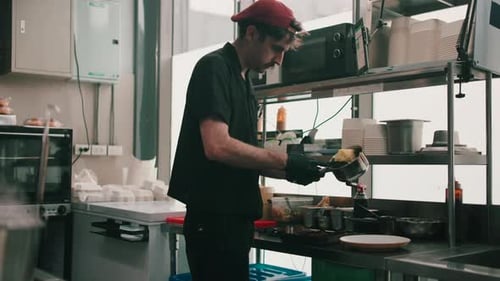 Professional Chef Plating Food in Commercial Kitchen