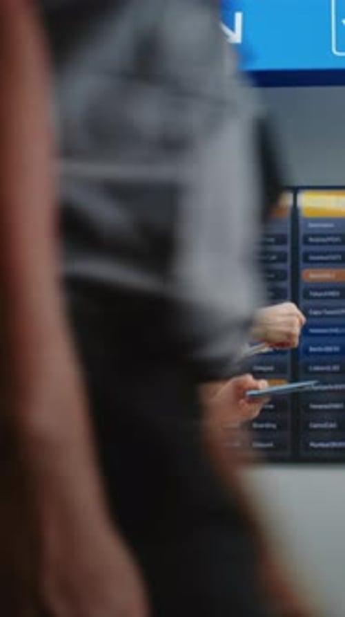 Airport Terminal Woman with Luggage and Ticket Checks Her Flight on Digital Departure Board