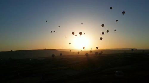 Hot Air Balloons Floating Over Desert at Sunrise