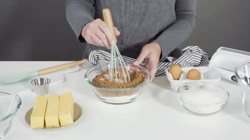 Woman Whisking Baking Ingredients in Glass Bowl