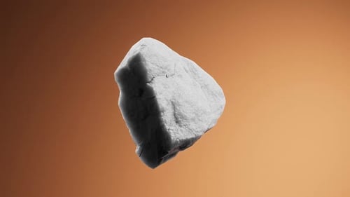 Dynamisches Gestein schwebt anmutig vor einem warmen orangefarbenen Hintergrund