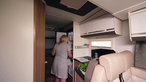 Woman Taking Pineapple from Refrigerator in RV Kitchen