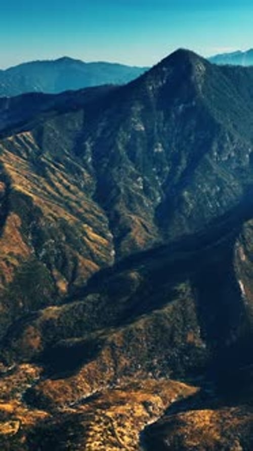 Panorama of stunning huge mountains covered with blue light. Californian rocky landscape at sunset.