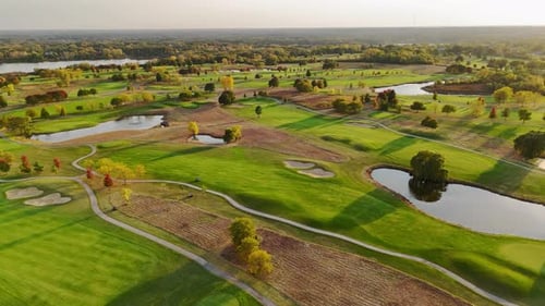 Aerial View of a Lush Golf Course with Water Features A Scenic Aerial View of a Green Golf Course