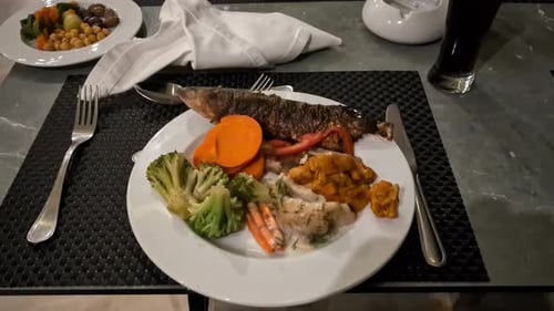 Fish cod with vegetables dining food at all inclusive resort in Egypt