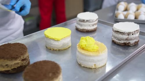 Delicious cakes making in bakery. Pastry chef cooking sweet dessert.