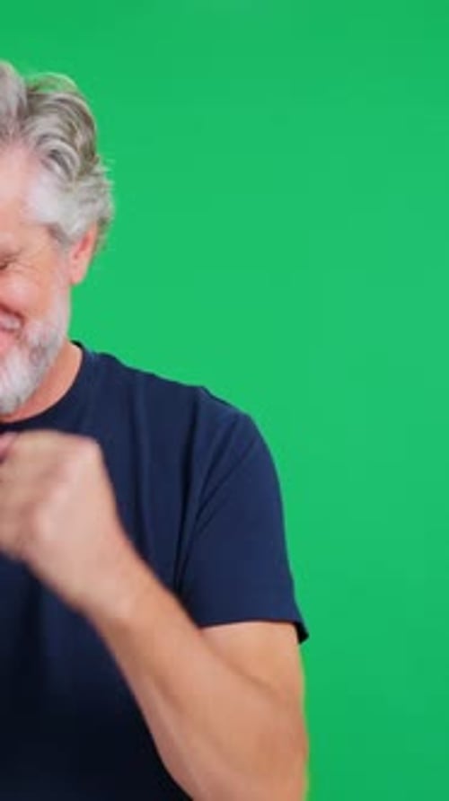 Happy Older Man Celebrating Energetically on Green Screen Background