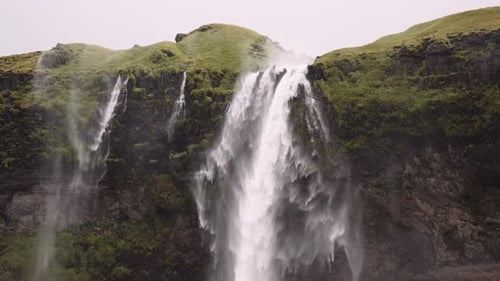 Waterfall Cascades Down Lush Mossy Rocks