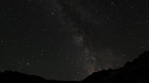 View of night stars sky above mountains