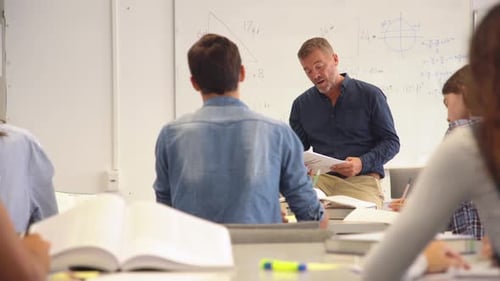 Professor Pointing At College Student With Hand Raised. Student Raising A Hand With A Question Fo...