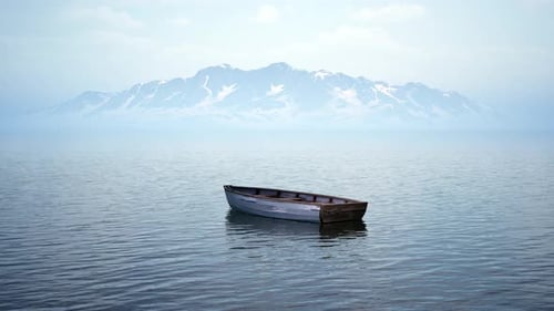 Peaceful Rowboat Floating on Calm Lake with Mountains