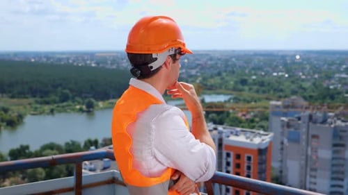 Construction Worker Overseeing City Building Project