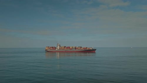 Large industrial cargo ship with containers sailing in the sea