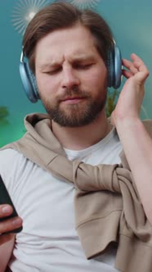 Man with Headphones Listening to Music Indoors