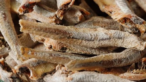 Dry Salty Fish Anchovies on a Plate Closeup Dried Fish Snack for Beer Party at the Cafe or Bar