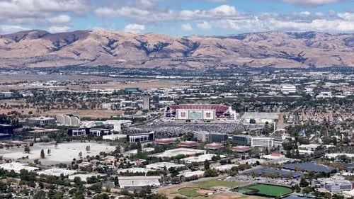 Levi's Stadium aerial view with the surrounding Silicon Valley landscape and distant hills under a c