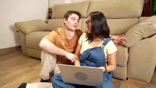 Young Couple Using Laptop Together at Home