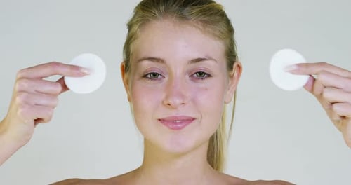 Woman Removes Cotton Pads, Smiling