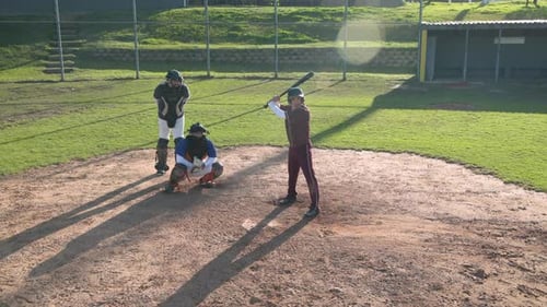 Playing baseball, batter running to first base while catcher and umpire watch