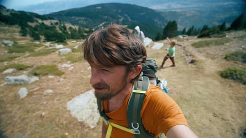 Travel Blogger Hiking with Backpack on Mountain Filming Himself Selfie Vlog