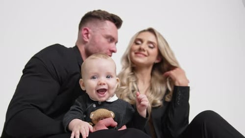Adorable Caucasian grey-eyed baby smiling to camera.