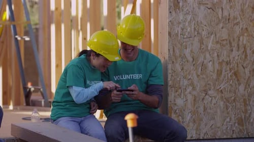 Volunteers Take a Break on Construction Site