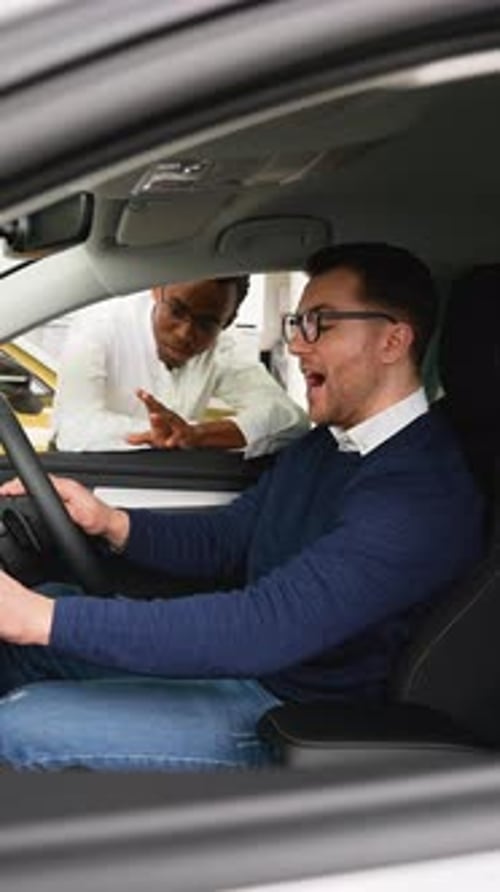 Salesman Showing Car Interior to Buyer in RightHand Drive Car
