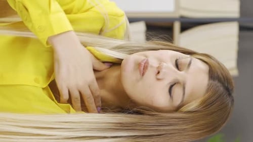 Woman Rubbing Head and Neck in Discomfort